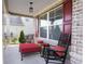 Cozy front porch with rocking chairs, an ottoman, and red accents at 126 Oakleigh Pointe Dr, Dallas, GA 30157