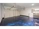 Spacious two-car garage with epoxy flooring, modern door openers, and additional refrigerator at 126 Oakleigh Pointe Dr, Dallas, GA 30157
