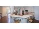 Spacious kitchen featuring a breakfast bar, stainless steel appliances, and gray cabinetry at 126 Oakleigh Pointe Dr, Dallas, GA 30157
