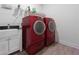 Spacious laundry room with red Samsung washing machine and dryer at 126 Oakleigh Pointe Dr, Dallas, GA 30157