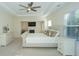 Spacious main bedroom with a tray ceiling, fireplace, sitting area, and bright windows at 126 Oakleigh Pointe Dr, Dallas, GA 30157