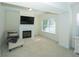 Cozy sitting room with fireplace, large TV, and bright windows at 126 Oakleigh Pointe Dr, Dallas, GA 30157