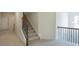 Carpeted stairs with decorative iron railing lead to the second floor at 126 Oakleigh Pointe Dr, Dallas, GA 30157