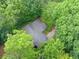 Aerial view of the property showcasing a roof, driveway and lush surrounding of mature trees at 1260 Willeo Creek Dr, Roswell, GA 30075