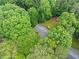 Overhead view of the property surrounded by mature trees, offering a private backyard setting at 1260 Willeo Creek Dr, Roswell, GA 30075