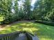 A spacious backyard is complete with mature trees and lush lawn at 1260 Willeo Creek Dr, Roswell, GA 30075