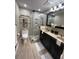 A modern bathroom is complete with a glass shower, dual vanity, and updated fixtures at 1260 Willeo Creek Dr, Roswell, GA 30075