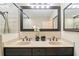 Bright bathroom features a double vanity with stone countertops and a modern framed mirror at 1260 Willeo Creek Dr, Roswell, GA 30075