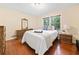Charming bedroom with a large window, hardwood floors, and classic furnishings at 1260 Willeo Creek Dr, Roswell, GA 30075