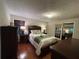 A cozy bedroom features wood floors, neutral walls, and a door leading to another bedroom at 1260 Willeo Creek Dr, Roswell, GA 30075