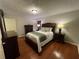 A cozy bedroom offers wood floors, neutral walls, and comfortable furnishings at 1260 Willeo Creek Dr, Roswell, GA 30075