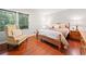 Bedroom features hardwood floors, bright windows, a cozy chair, and comfortable furnishings at 1260 Willeo Creek Dr, Roswell, GA 30075