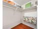 Walk-in closet featuring custom shelving and hardwood floors at 1260 Willeo Creek Dr, Roswell, GA 30075