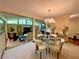 Dining room with a glass table, chandelier, and view to the living room at 1260 Willeo Creek Dr, Roswell, GA 30075