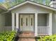 Inviting covered entryway with white columns and decorative glass front door at 1260 Willeo Creek Dr, Roswell, GA 30075