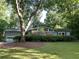 Charming one-story home with stone accents and a well-maintained lawn with mature shade trees at 1260 Willeo Creek Dr, Roswell, GA 30075