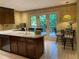 An eat-in kitchen includes an island with a sink and door leading to the backyard at 1260 Willeo Creek Dr, Roswell, GA 30075