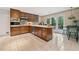 Classic kitchen featuring wood cabinetry, modern appliances, and an inviting breakfast nook at 1260 Willeo Creek Dr, Roswell, GA 30075