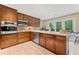 Well-equipped kitchen with wood cabinets and stainless appliances, offering ample workspace at 1260 Willeo Creek Dr, Roswell, GA 30075