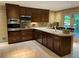 An eat-in kitchen offers updated appliances, white countertops, and wood cabinets at 1260 Willeo Creek Dr, Roswell, GA 30075