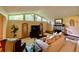 Bright living room featuring large windows, a stone fireplace, and comfortable furnishings at 1260 Willeo Creek Dr, Roswell, GA 30075