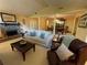 Traditional living room with a stone fireplace, plush seating, and access to the formal dining area at 1260 Willeo Creek Dr, Roswell, GA 30075