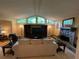 Spacious living room featuring a stone fireplace, large windows, and comfortable seating area at 1260 Willeo Creek Dr, Roswell, GA 30075