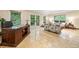 Comfortable office features travertine flooring, desk, and access to back patio at 1260 Willeo Creek Dr, Roswell, GA 30075