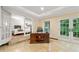 Bright home office with tile floors, french doors, and desk with executive chair at 1260 Willeo Creek Dr, Roswell, GA 30075