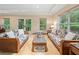 Inviting sunroom filled with natural light, perfect for relaxation and enjoying garden views at 1260 Willeo Creek Dr, Roswell, GA 30075