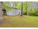 The backyard offers lush greenery, mature trees, and a patio; a serene outdoor setting at 3084 Fern Valley Sw Dr, Marietta, GA 30008