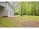 Expansive backyard features lush grass, patio, and mature trees offering natural beauty at 3084 Fern Valley Sw Dr, Marietta, GA 30008