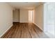 A large room featuring laminate flooring, neutral walls, and a glass paneled sliding door at 3084 Fern Valley Sw Dr, Marietta, GA 30008