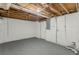 Unfinished basement with white-painted walls and exposed ceiling; door and utilities shown at 3084 Fern Valley Sw Dr, Marietta, GA 30008