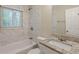 Elegant bathroom featuring tub, marble tiled walls, granite vanity, and a window at 3084 Fern Valley Sw Dr, Marietta, GA 30008