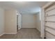 Finished basement bedroom with tan carpet, neutral walls, and closet with built-in shelves at 3084 Fern Valley Sw Dr, Marietta, GA 30008