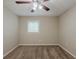 A simple bedroom with plush carpet, ceiling fan, and a bright window at 3084 Fern Valley Sw Dr, Marietta, GA 30008