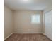 A simple bedroom featuring plush carpet, neutral walls, and a bright window near the closet at 3084 Fern Valley Sw Dr, Marietta, GA 30008