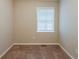 Cozy bedroom featuring neutral walls, plush carpeting, and a bright window with blinds at 3084 Fern Valley Sw Dr, Marietta, GA 30008