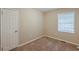 Cozy bedroom featuring neutral walls, plush carpeting, and a bright window with blinds at 3084 Fern Valley Sw Dr, Marietta, GA 30008
