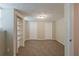 Finished basement bedroom with tan carpet features closet and built-in shelving unit at 3084 Fern Valley Sw Dr, Marietta, GA 30008