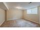 Finished basement bedroom with tan carpet and window allowing for natural light at 3084 Fern Valley Sw Dr, Marietta, GA 30008