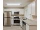 Bright kitchen features stainless steel appliances, white cabinets, granite countertops, and a window at 3084 Fern Valley Sw Dr, Marietta, GA 30008