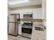 A modern kitchen includes stainless steel appliances, white cabinets, and granite countertops at 3084 Fern Valley Sw Dr, Marietta, GA 30008