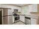 Modern kitchen features stainless steel appliances, white cabinets, granite countertops, and a bright window at 3084 Fern Valley Sw Dr, Marietta, GA 30008