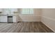 An open room with grey wood floors, white trim, and a large window at 3084 Fern Valley Sw Dr, Marietta, GA 30008