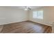 Room with dark wood floors, white trim, large window, and a ceiling fan at 3084 Fern Valley Sw Dr, Marietta, GA 30008