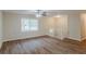 An open room with dark wood floors, white trim, and a staircase with white railings at 3084 Fern Valley Sw Dr, Marietta, GA 30008