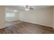 An open room with dark wood floors, white trim, and a large window at 3084 Fern Valley Sw Dr, Marietta, GA 30008