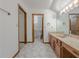 Bathroom with dual sinks, wooden cabinetry and tile floors at 3835 Shawnee Sw Run, Lilburn, GA 30047